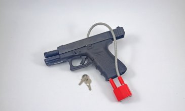 Photo of a hand gun with a safety lock attached to it