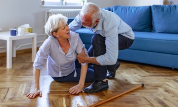 A woman falling to the ground and a man helping her