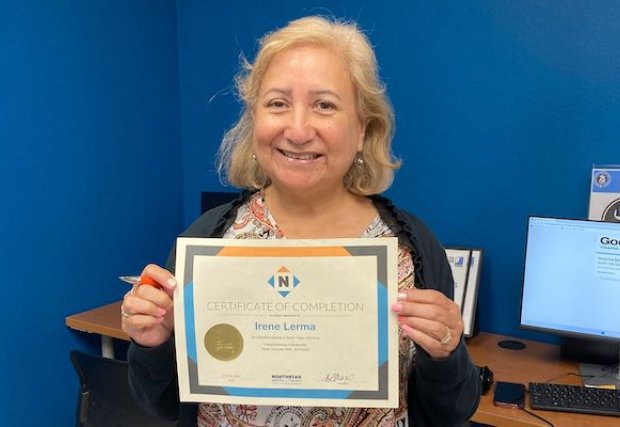 Irene Lerma holding her Goodwill certificate of completion