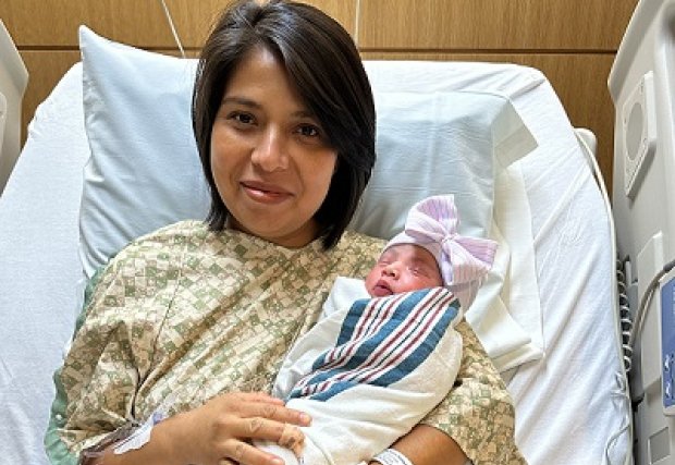 Baby Eunice and her mom posing on their hospital bed