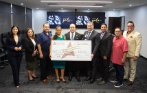 The STHS McAllen and South Texas College teams holding the large check