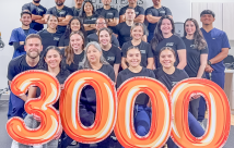 STHS McAllen Outpaitent Rehab Center Staff poses with 3000-shaped Mylar balloons
