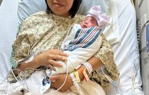 Baby Eunice and her mom posing on their hospital bed